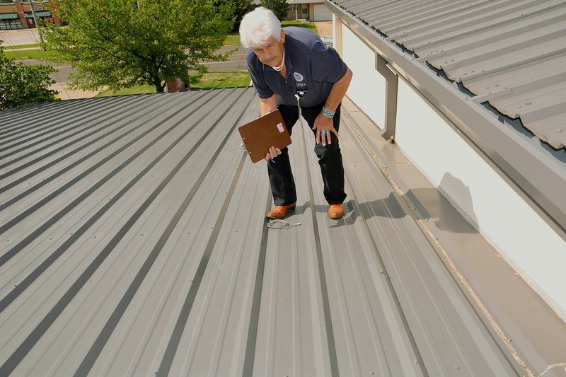 Inspector documenting damage on a roof