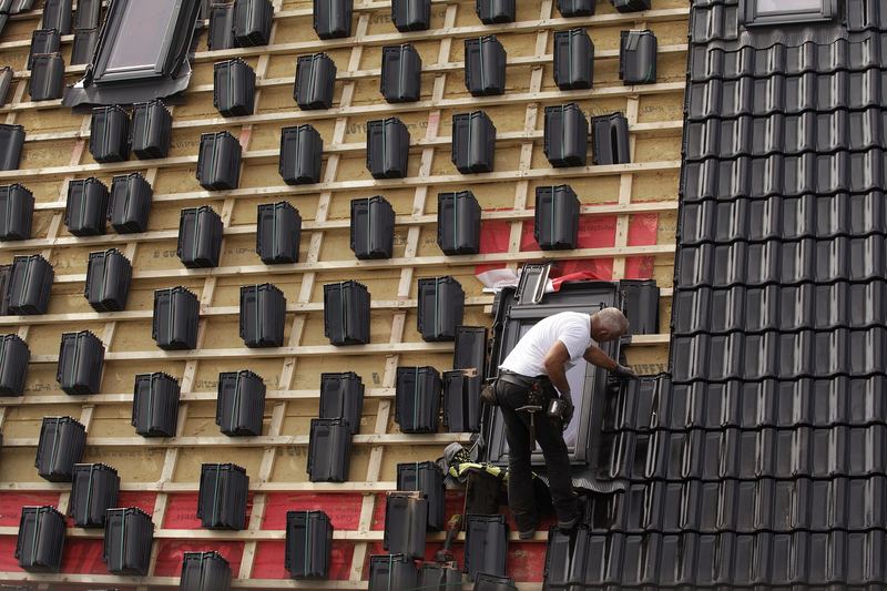 Roof tiles loaded onto battens before fixing